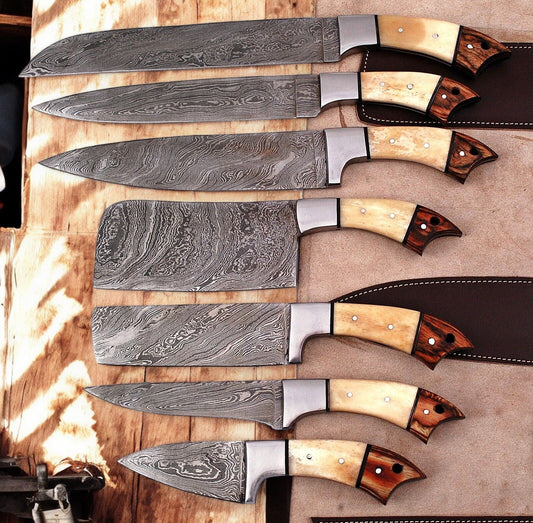 Handmade Damascus kitchen knives set with wooden handles, displayed in a leather roll for professional culinary use.