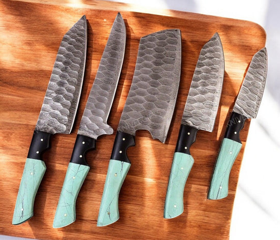 Handmade Damascus kitchen knives set with epoxy resin handles, featuring intricate blade patterns and ergonomic design.