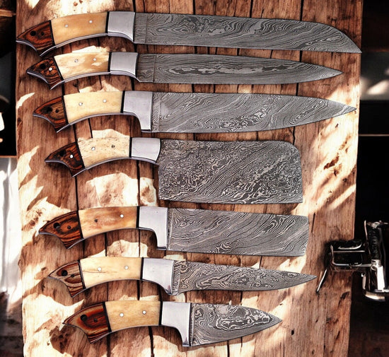 Handmade Damascus kitchen knives set with leather roll, featuring polished blades and leather storage for professional cooking tools.