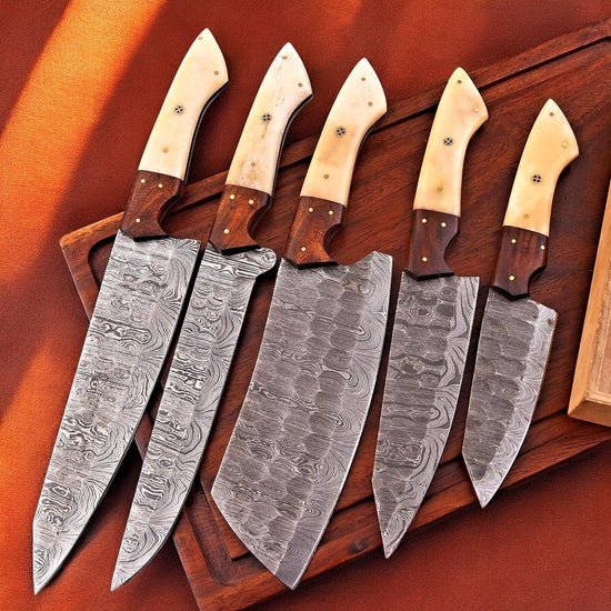 Handmade Damascus kitchen knives set with bone and rosewood handles, featuring sharp blades and detailed craftsmanship.