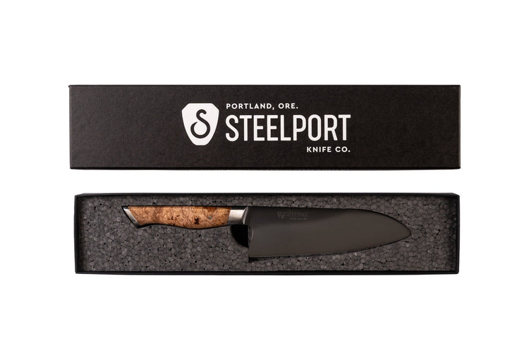Steelport 6-inch chef knife with a stainless steel blade and black handle, displayed in a box for kitchen use.
