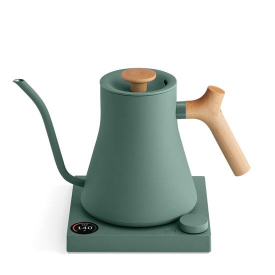 Fellow Stagg EKG Pro electric kettle in smoke green with a maple handle, showcasing its sleek design and digital controls.
