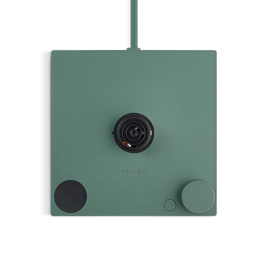 Fellow Stagg EKG Pro electric kettle in smoke green with maple handle, featuring a sleek design and digital temperature control.