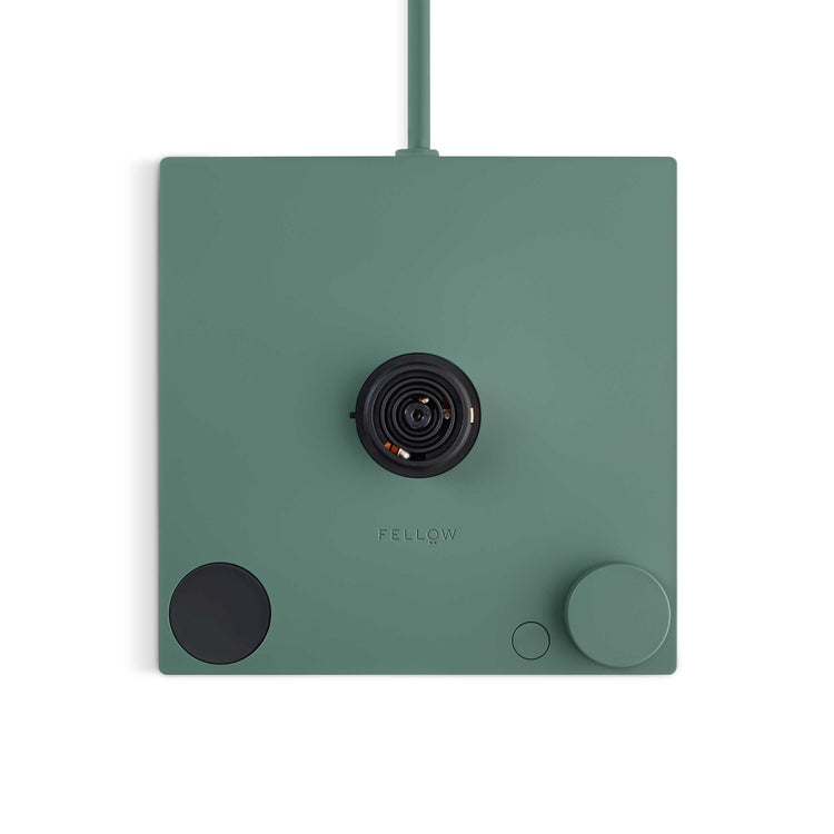 Fellow Stagg EKG Pro electric kettle in smoke green with maple handle, featuring a sleek design and digital temperature control.
