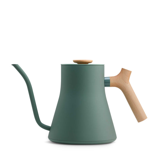 Fellow Stagg EKG Pro electric kettle in smoke green with maple wood handle, featuring sleek design and digital temperature control.