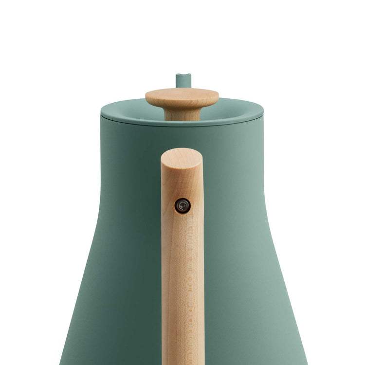 Fellow Stagg EKG Pro electric kettle in smoke green with maple handle, featuring a sleek design and digital temperature control.
