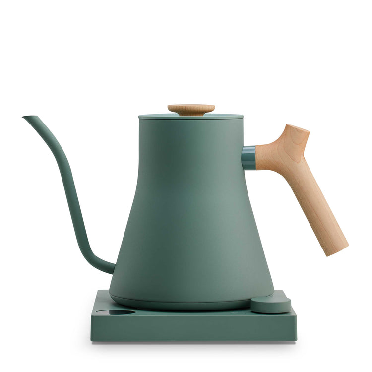 Fellow Stagg EKG Pro electric kettle in smoke green with maple handle, showcasing its sleek design and digital controls.