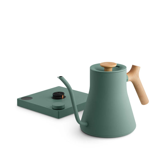Fellow Stagg EKG Pro electric kettle in smoke green with maple handle, showcasing sleek design and digital controls.