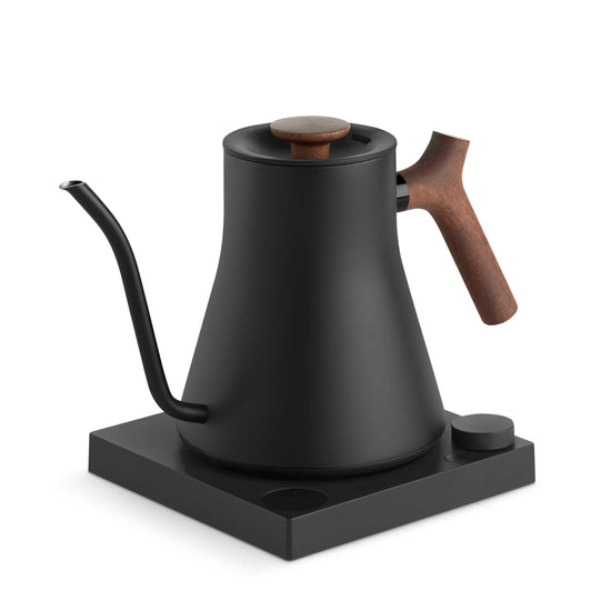 Fellow Stagg EKG Pro electric kettle in matte black with walnut handle, showcasing its sleek design and digital control panel.