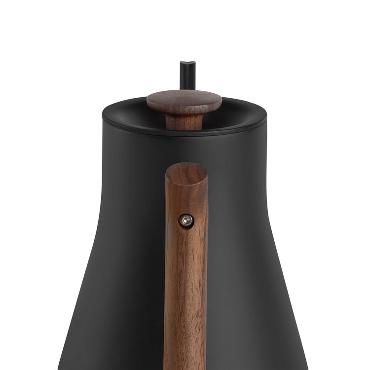 Fellow Stagg EKG Pro electric kettle in matte black with walnut handle, showcasing a sleek, modern design with a digital control panel.