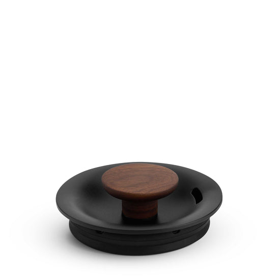 Fellow Stagg EKG Pro electric kettle in matte black with walnut wood accents, designed for precise pouring and brewing.