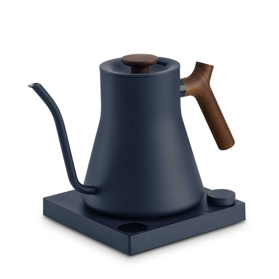 Fellow Stagg EKG Pro electric kettle in stone blue with walnut handle, featuring sleek design and digital temperature control.