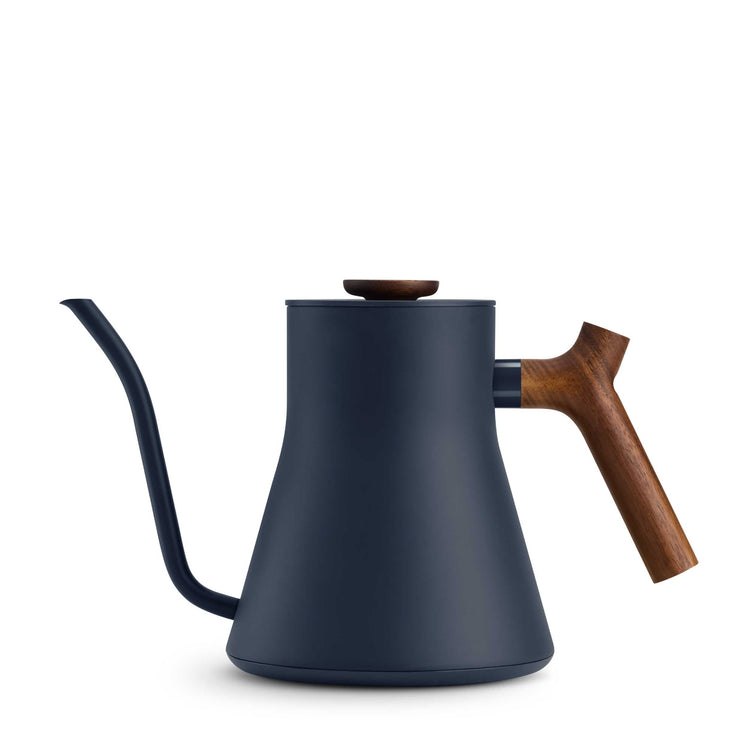 Fellow Stagg EKG Pro electric kettle in stone blue with walnut handle and accents, showcasing a sleek, modern design.