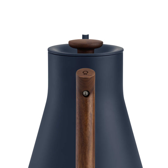 Fellow Stagg EKG Pro electric kettle in stone blue with walnut handle, featuring a sleek design and digital temperature control.