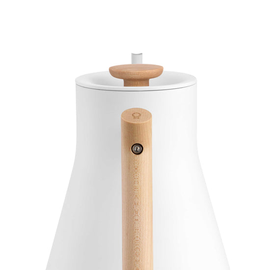 Fellow Stagg EKG Pro electric kettle in matte white with maple handle and accents, designed for precise pour-over brewing.
