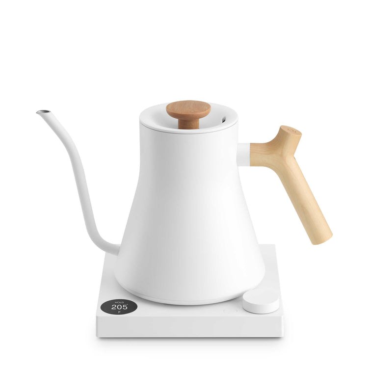 Fellow Stagg EKG Pro electric kettle in matte white with maple accents, featuring a sleek design and digital control panel.
