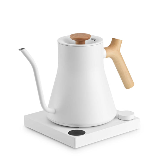 Fellow Stagg EKG Pro electric kettle in matte white with maple handle, featuring a sleek design and digital temperature control.