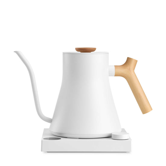 Fellow Stagg EKG Pro electric kettle in matte white with maple handle, featuring a sleek design and digital temperature control.