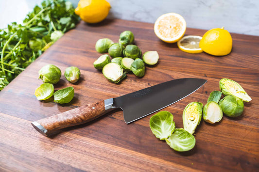 Steelport 6-inch chef knife with a sharp blade, shown next to fresh Brussels sprouts, ideal for precise kitchen slicing and chopping.