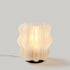 Mini Wavy Lamp by Wooj Design, sculptural 3D printed table lamp in amber with a wavy, artistic design.