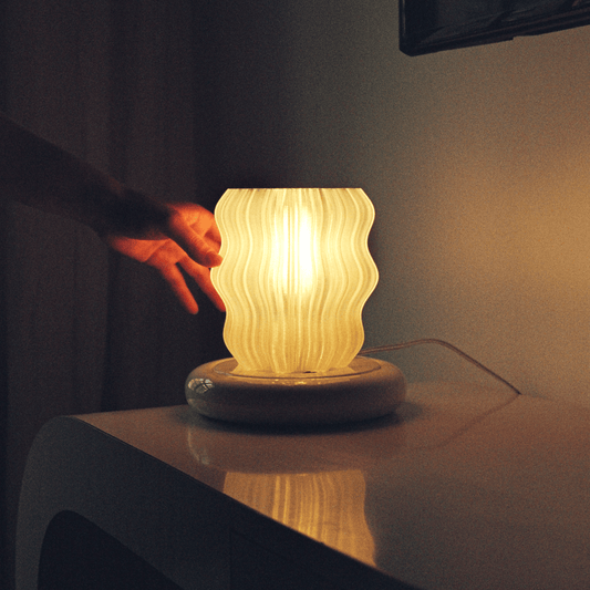 Amber Mini Wavy Lamp by Wooj Design, a sculptural 3D printed table lamp with flowing wave design and warm glow.