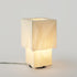 Modern Farolito Lamp by Wooj Design featuring warm ambient lighting and a sleek accent table lamp design.