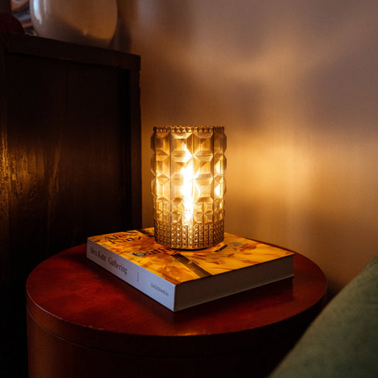 Wooj Design Gem Lamp with faceted glass body emitting warm ambient light, modern decorative table lamp.