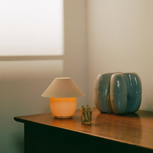 Wooj Design Scoop Lamp with an eggshell finish, featuring a smooth, rounded shape and modern aesthetic for stylish home lighting.