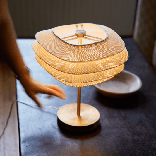 Brass Arcas Lamp by Wooj Design featuring a sleek, modern lamp with a minimalist design and warm brass finish.