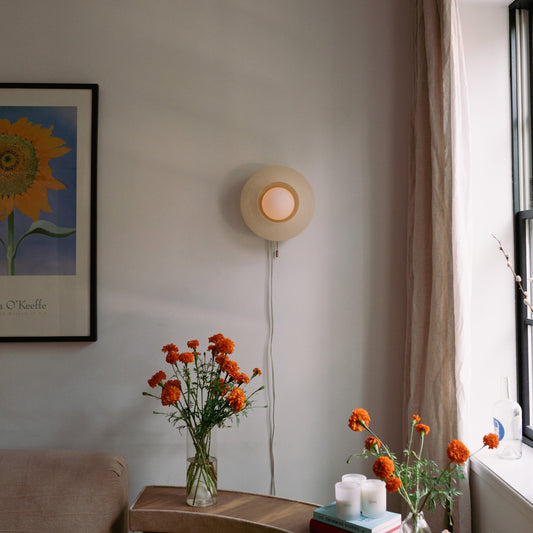 Eggshell Helios Sconce lamp by Wooj Design featuring a sleek, modern wall-mounted lighting fixture with a smooth finish.