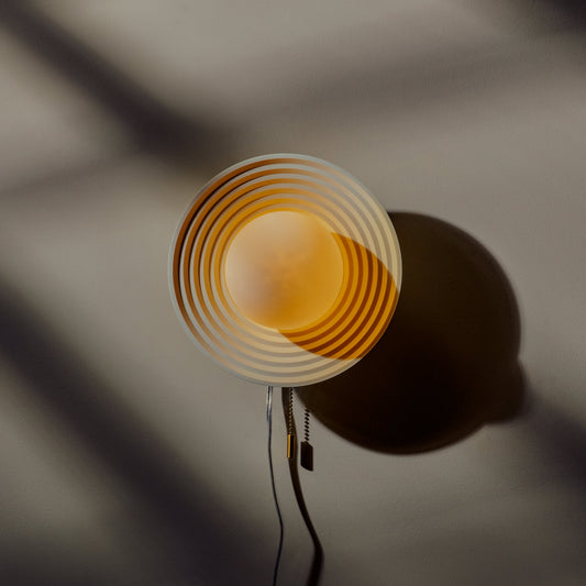 Matte black Wooj Design Echo Sconce lamp mounted on a wall, modern lighting fixture with a sleek, minimalist design.