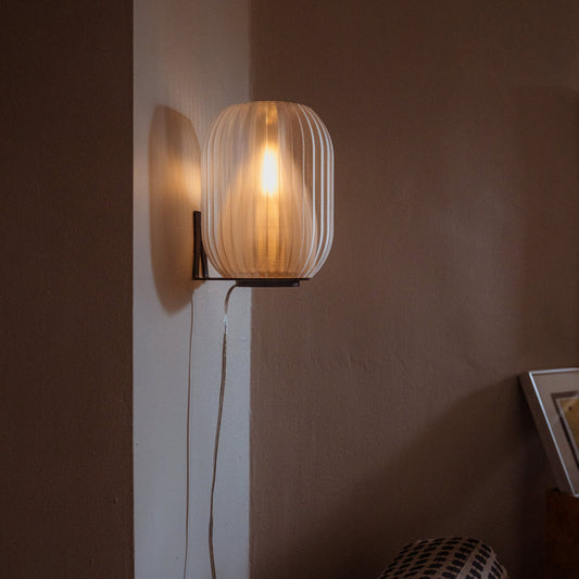 Smoke Allium Sconce by Wooj Design featuring a modern, sculptural glass light fixture for stylish interior lighting.