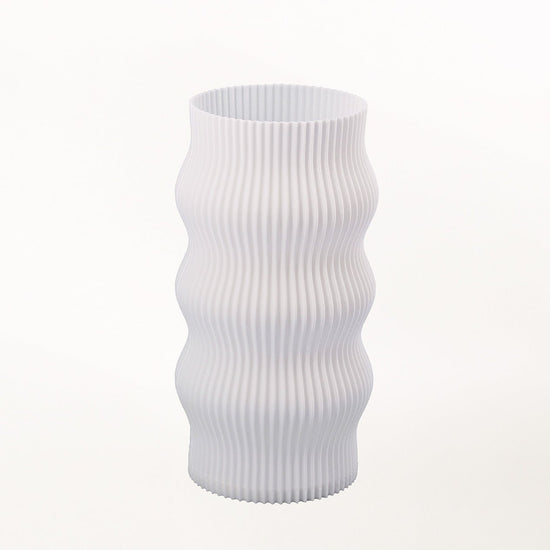 Terra Labs Wub Table Lamp with a sleek, modern design featuring a rounded base and a soft illuminated shade on a wooden surface.