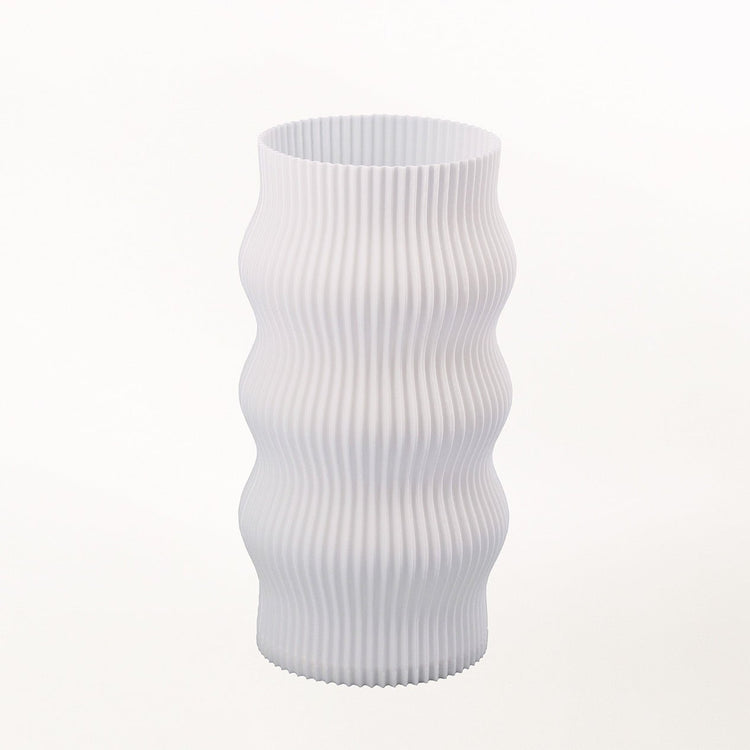 Terra Labs Wub Table Lamp with a sleek, modern design featuring a rounded base and a soft illuminated shade on a wooden surface.