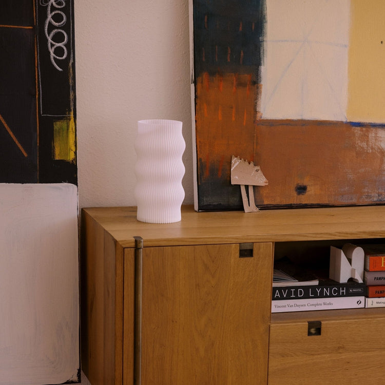 Terra Labs Wub Table Lamp with modern design, featuring a sleek base and a soft glowing lampshade for ambient lighting.