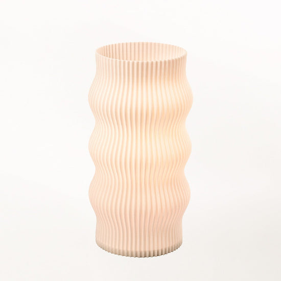 Terra Labs Wub Table Lamp with a sleek, modern design featuring a curved base and a cylindrical lampshade.